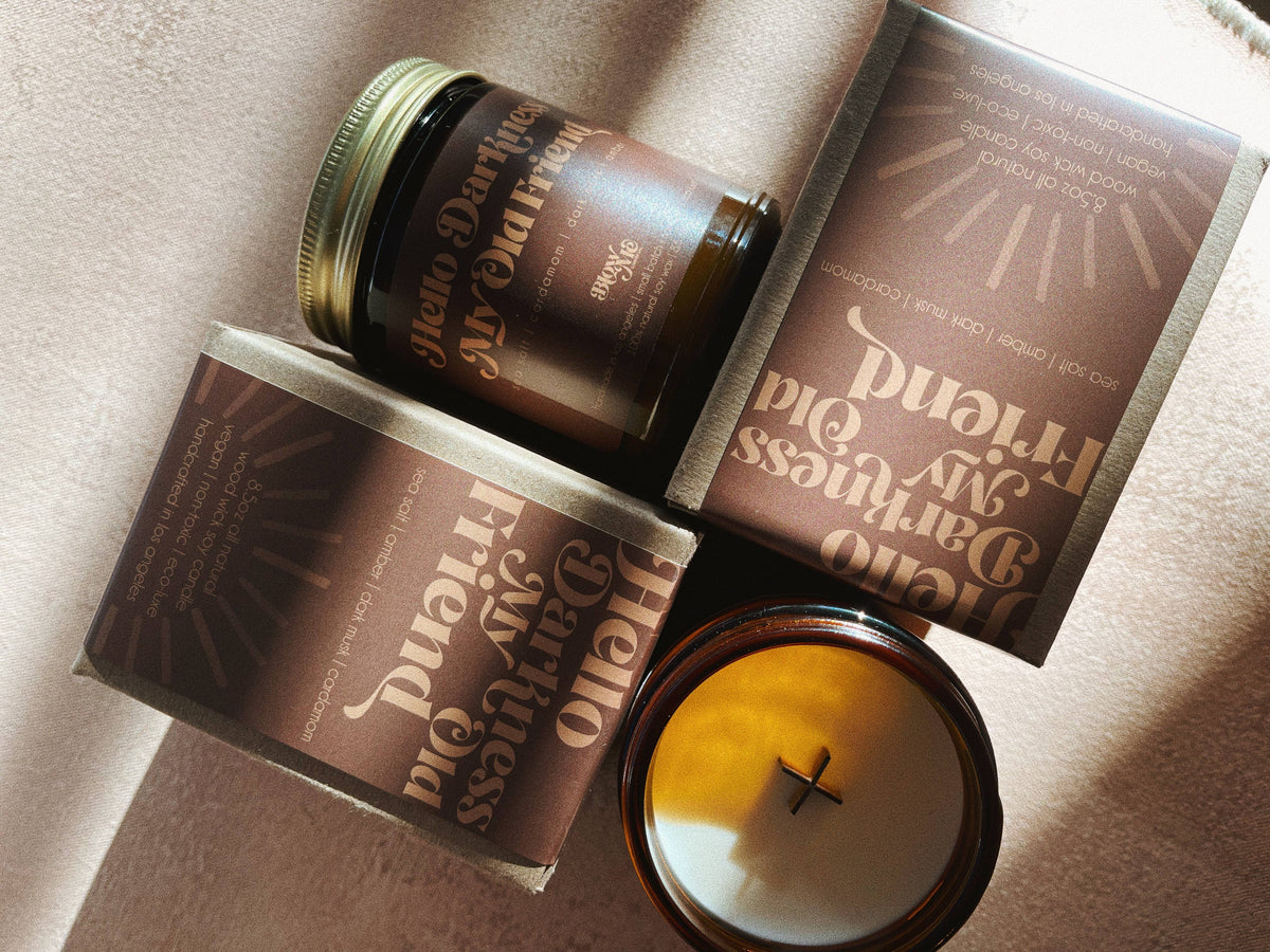 Small batch candle with the quote hello darkness my old friend. Notes of sea salt, amber, dark musk, and cardamom.
