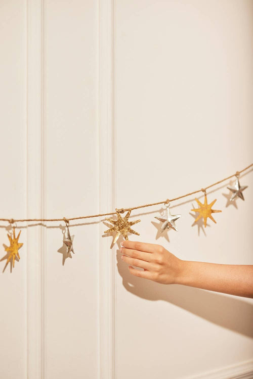 Silver and gold upcycled iron stars and suns on a jute rope. Indoor or outdoor wall hanging.